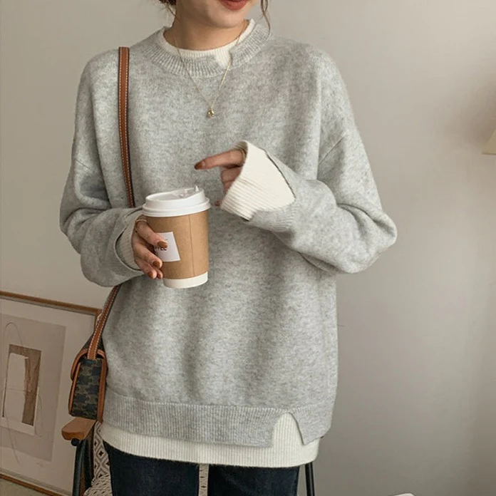 Light gray knitted sweater worn by woman holding coffee cup | Grace Aura