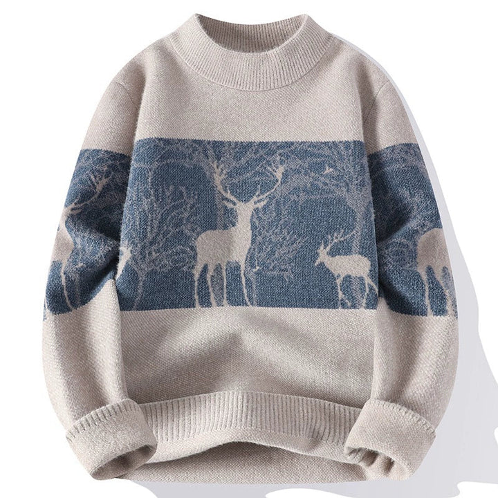 Beige knit sweater with blue reindeer forest pattern, laid flat | Grace Aura