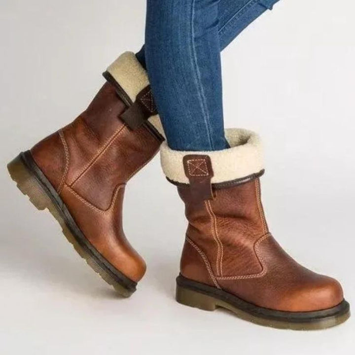 Brown leather boots with cream fur-lined cuffs, worn by person | Grace Aura