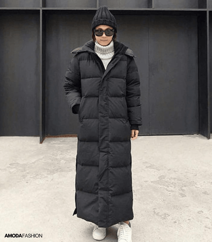 Black hooded oversized long puffer coat worn by woman with sunglasses | Grace Aura