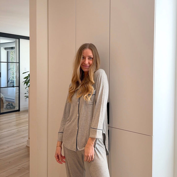Woman wearing grey ribbed long sleeve pyjama set with piping detail | Grace Aura
