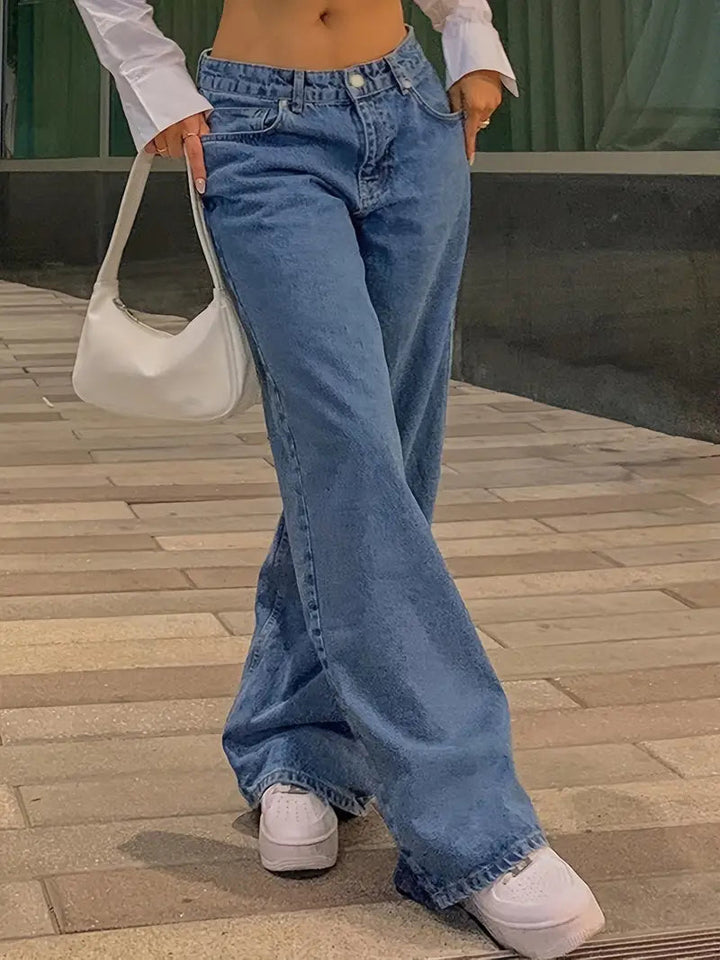 Woman wearing blue low-rise baggy denim jeans with white sneakers | Grace Aura