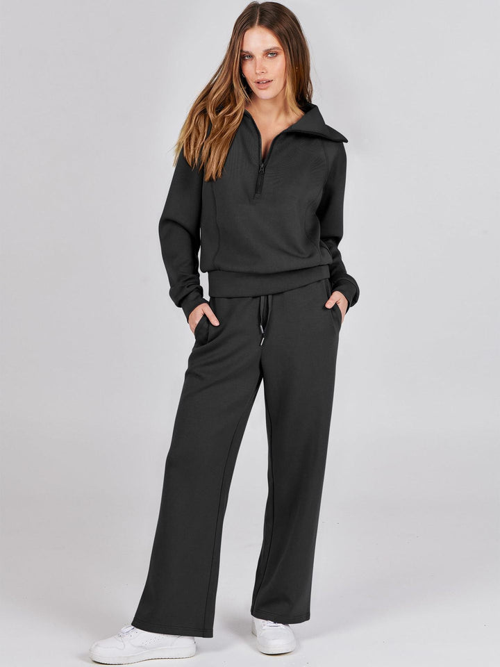 Woman wearing black half-zip sweatshirt and matching wide-leg pants, tracksuit set | Grace Aura
