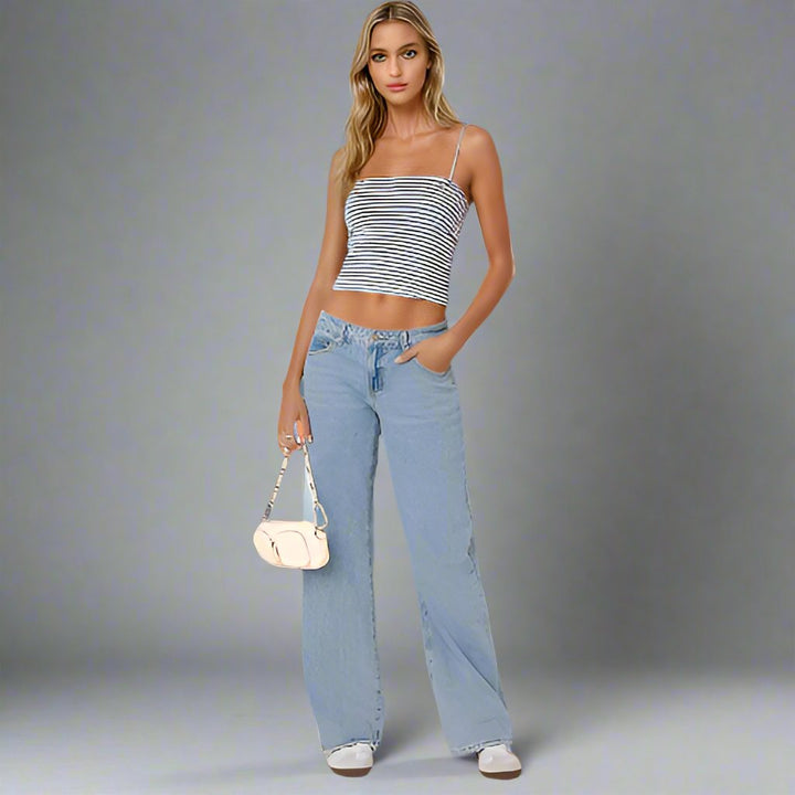 Woman wearing light blue wide-leg jeans and striped crop top | Grace Aura