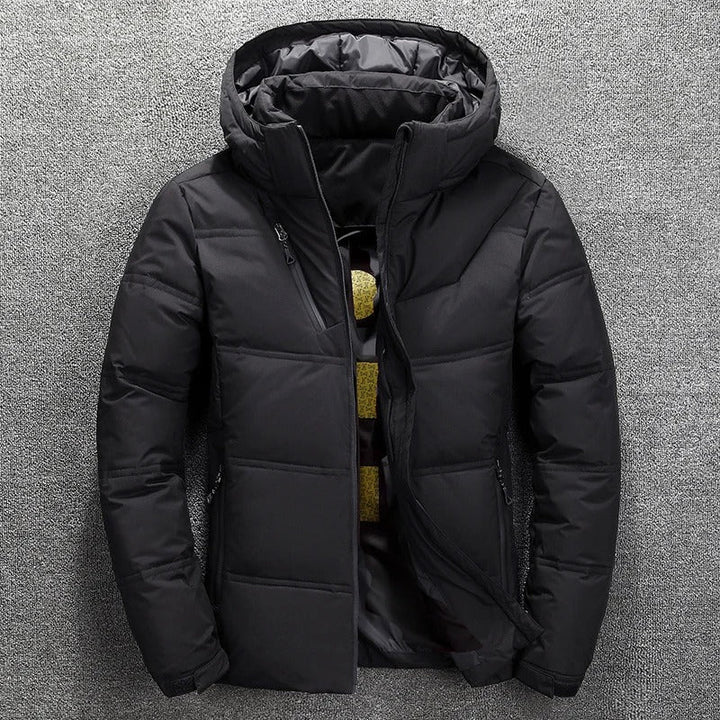 Black hooded puffer jacket with zip closure, displayed flat on fabric | Grace Aura