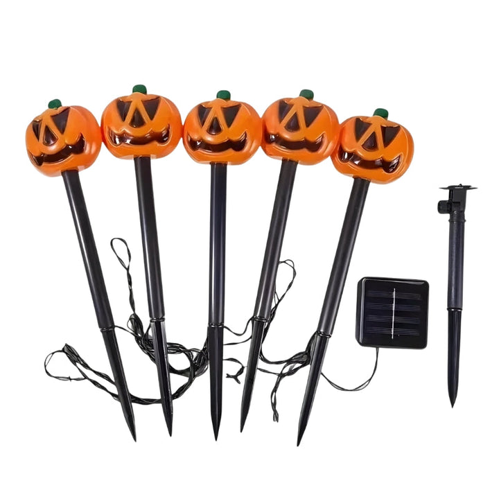 Five orange jack-o-lantern solar garden stake lights with black stands | Grace Aura