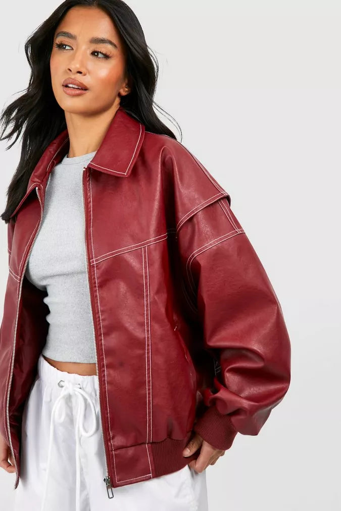 Woman wearing oversized burgundy faux leather bomber jacket with contrast stitching | Grace Aura