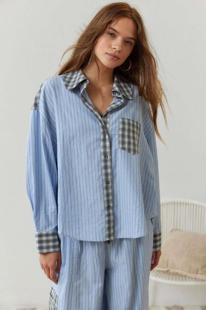 Woman wearing blue striped shirt with plaid trim and pocket detail | Grace Aura