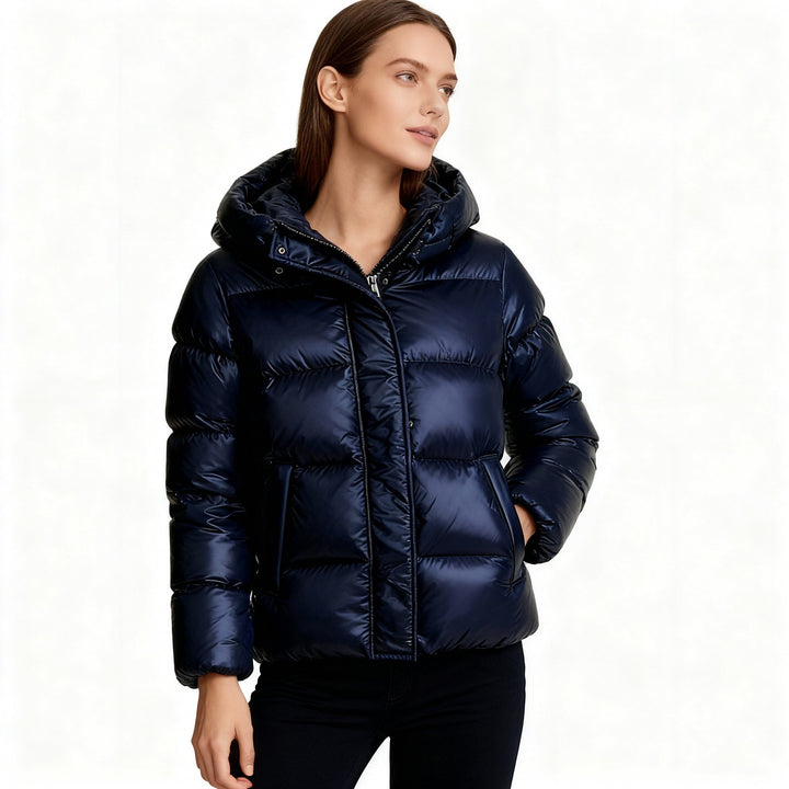 Woman wearing navy shiny hooded puffer jacket with black pants | Grace Aura
