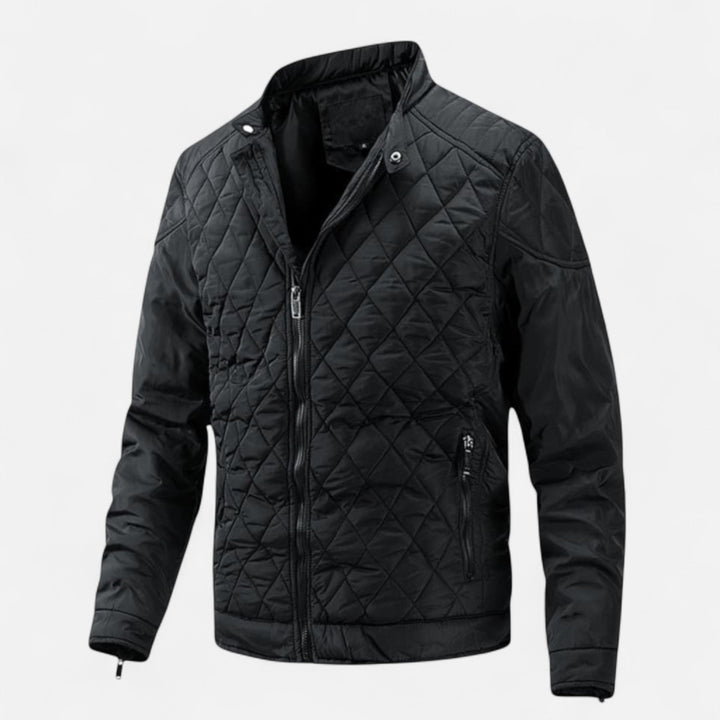 Black quilted diamond-pattern jacket with stand collar, worn by a person | Grace Aura