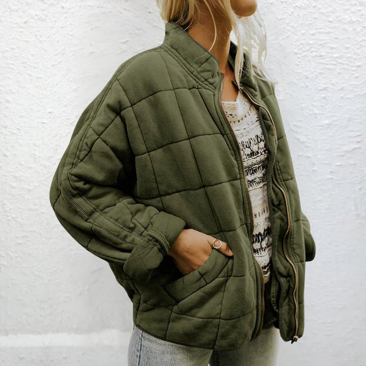 Woman wearing olive green quilted oversized jacket with zip front closure | Grace Aura