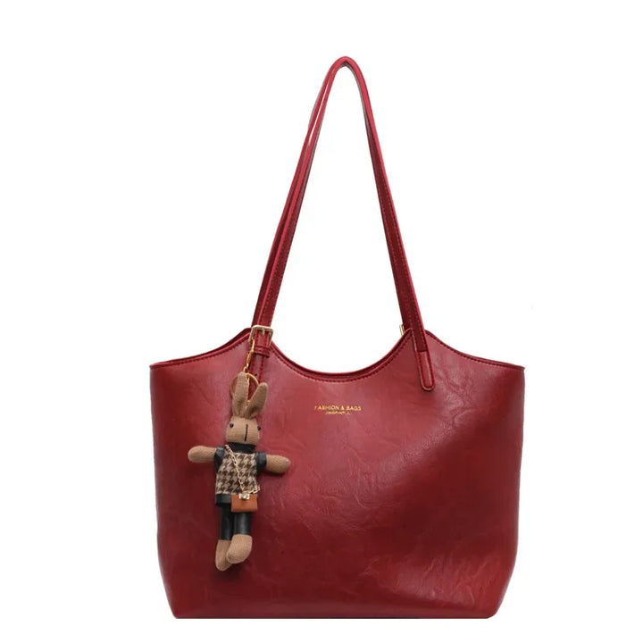 Red vegan leather tote bag with textured finish and bunny keychain charm | Grace Aura