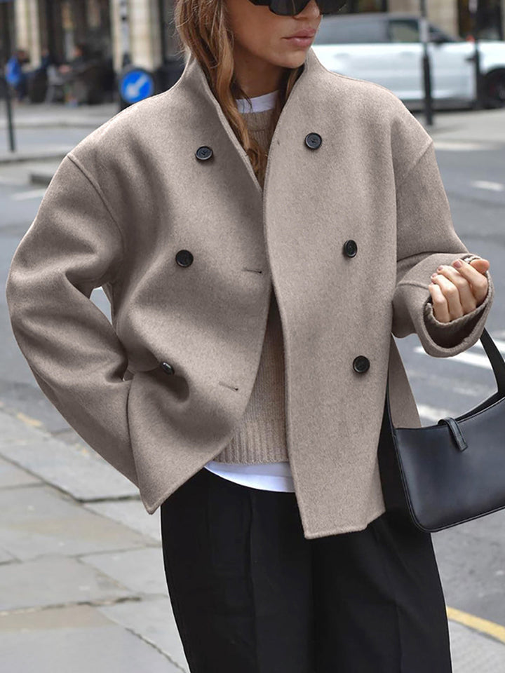 Beige double-breasted wool jacket worn by woman standing on city street | Grace Aura