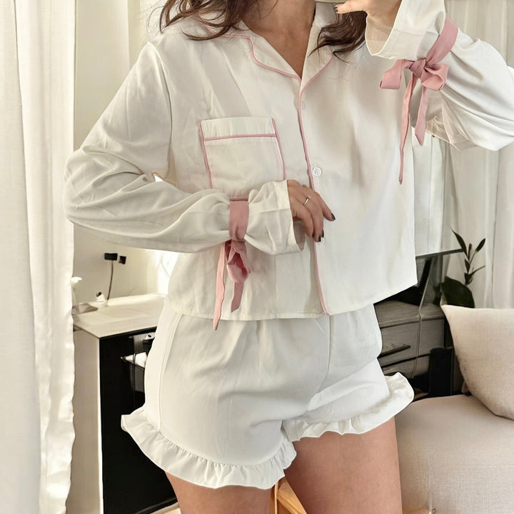 White cotton pyjama set with pink trim, worn by woman | Grace Aura