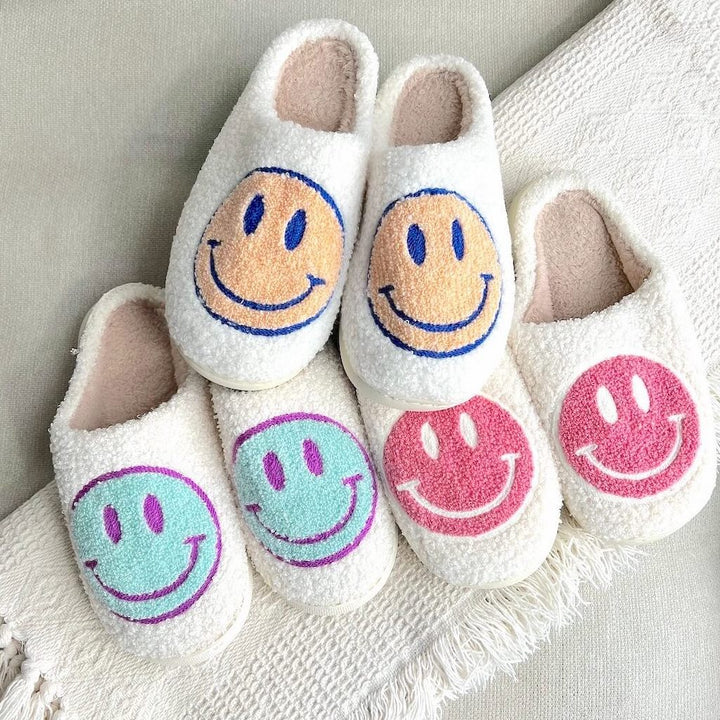 Three pairs fuzzy slippers with smiley face prints in pastel colors | Grace Aura