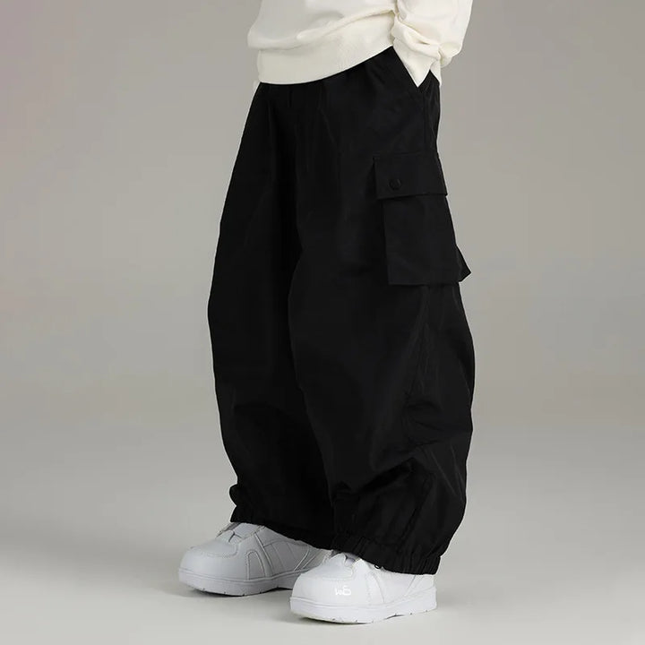 Black baggy cargo pants with side pocket, worn by person, white sneakers | Grace Aura