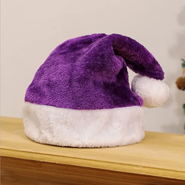 Purple plush Santa hat with white fur trim, displayed on wooden surface | Grace Aura