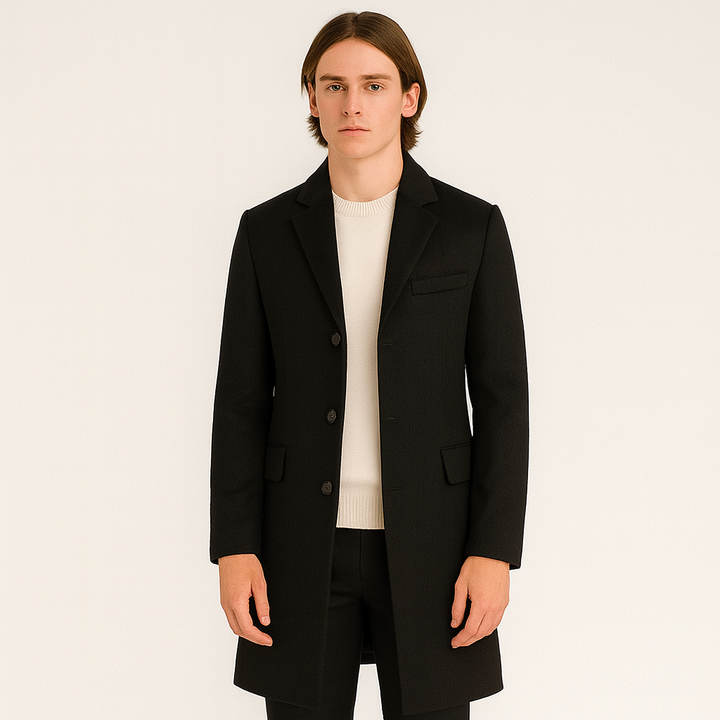 Man wearing black single-breasted wool coat with cream sweater and trousers | Grace Aura