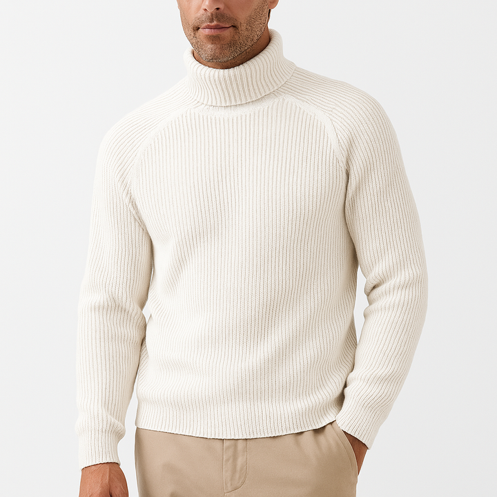 Man wearing cream ribbed knit turtleneck sweater with tan trousers, front view | Grace Aura