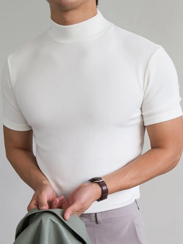 White mock neck short-sleeve t-shirt worn by man, holding jacket casually | Grace Aura