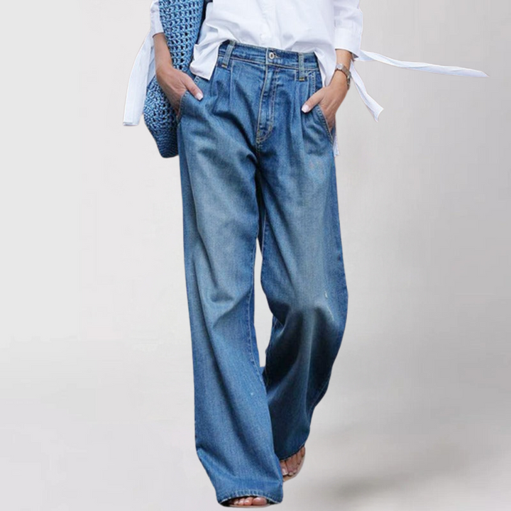 Blue denim wide-leg jeans, high-waisted, worn by woman standing | Grace Aura