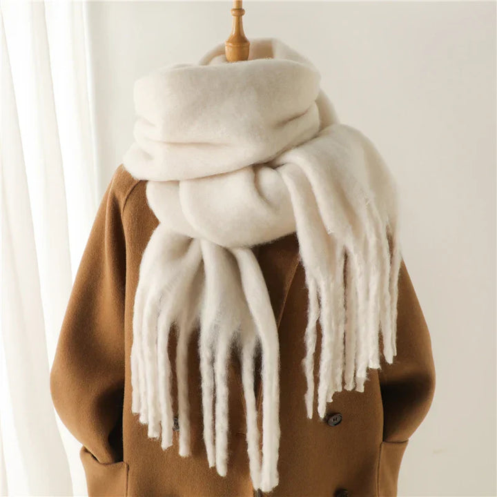 White chunky knit fringed scarf worn on mannequin over camel coat | Grace Aura