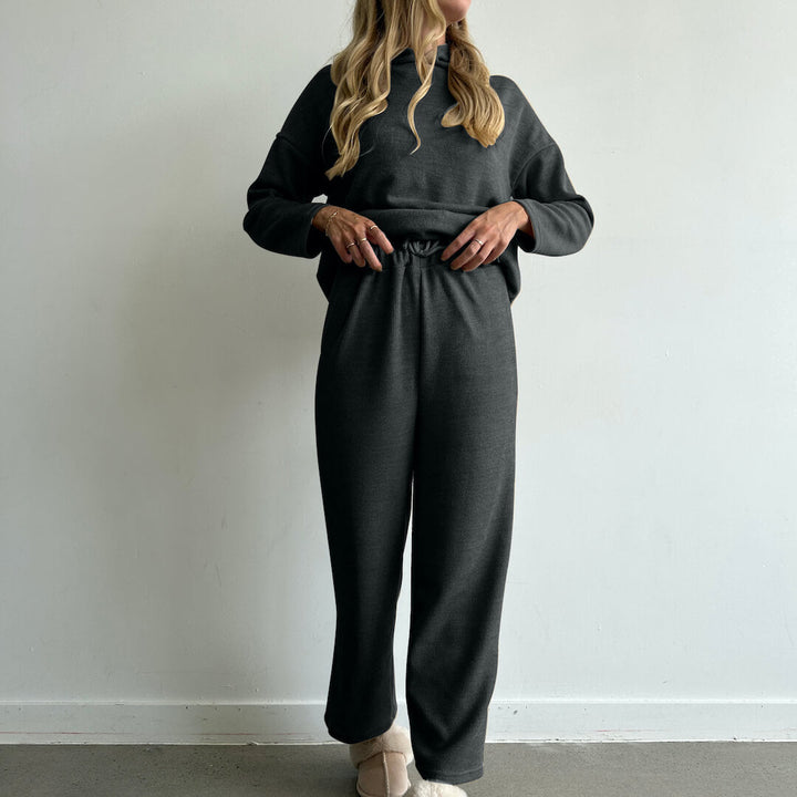 Woman wearing dark gray ribbed hoodie and matching wide-leg trousers, loungewear set | Grace Aura
