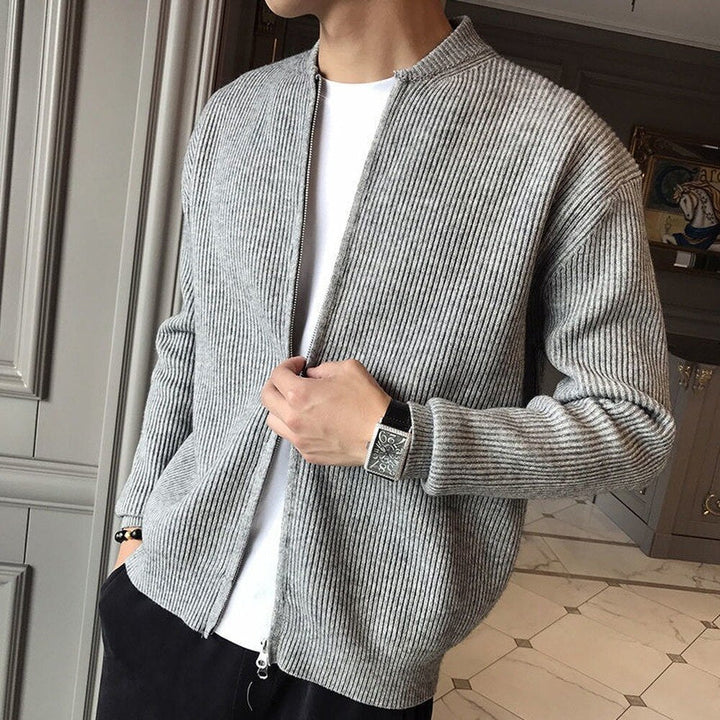 Man wearing gray ribbed knit zip-up cardigan over white shirt, black pants | Grace Aura