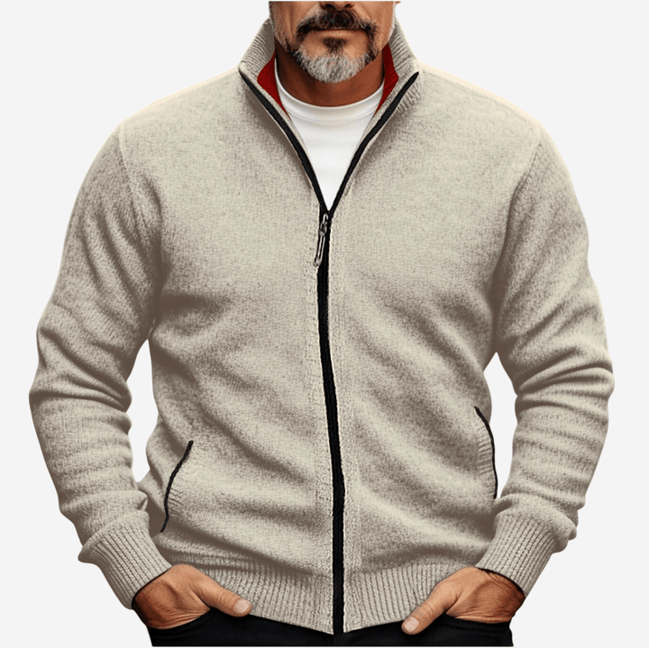Man wearing beige knitted zip-up cardigan with stand collar, hands in pockets | Grace Aura