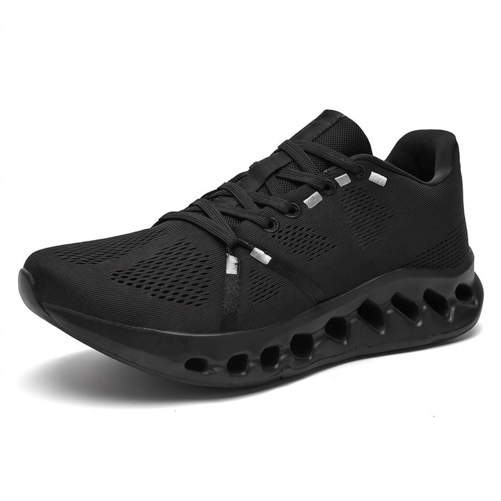 Black mesh running trainer with chunky wave-patterned sole, shown alone on white background | Grace Aura