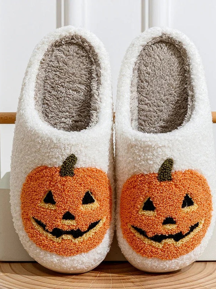 White fluffy slippers with a pumpkin face
