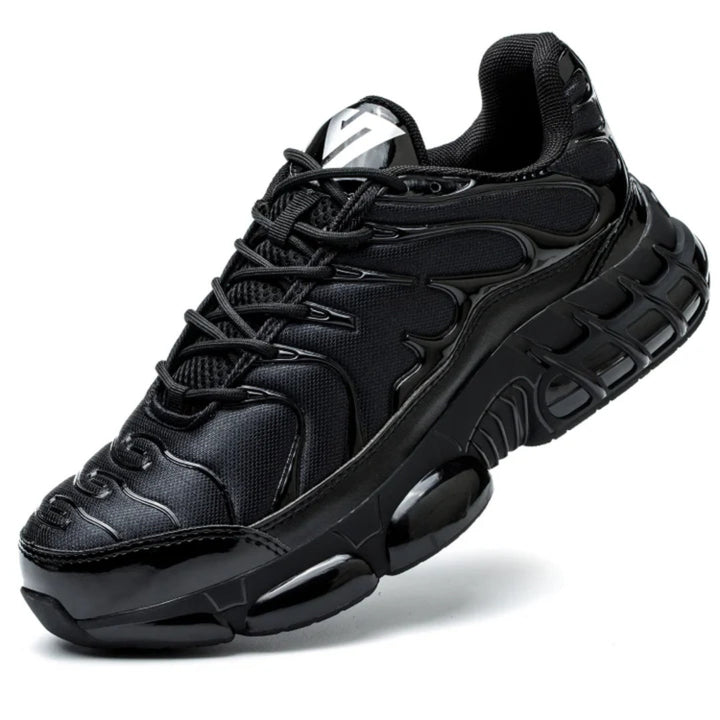Black chunky safety trainer with thick sole, shown at an angle | Grace Aura