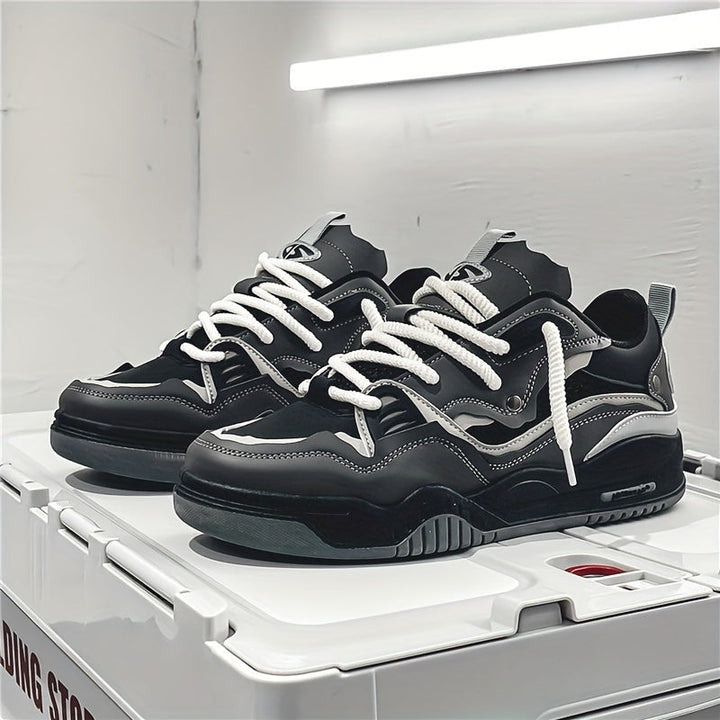 Black and gray chunky sneakers with white laces, flat, no model worn | Grace Aura