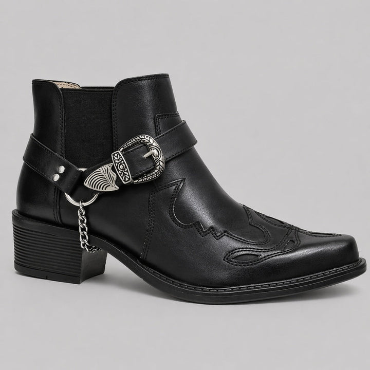 Black pointed-toe cowboy boot with buckle strap and chain detail, side view | Grace Aura