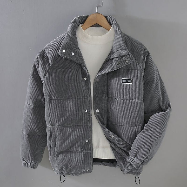 Gray corduroy puffer jacket with stand collar, shown on hanger | Grace Aura