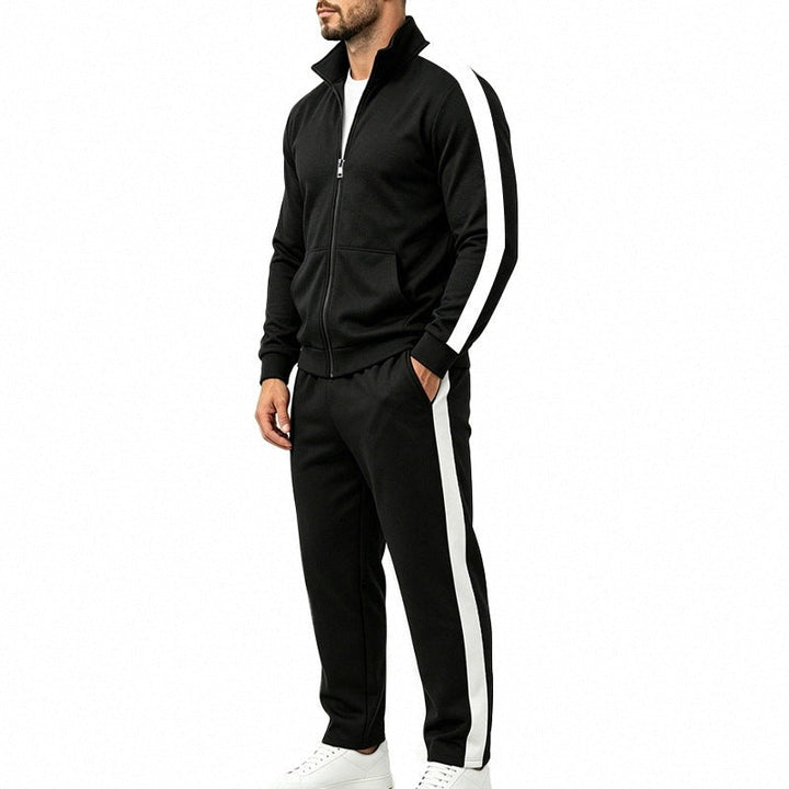 Man wearing black tracksuit with white stripe, jacket and pants, side view | Grace Aura