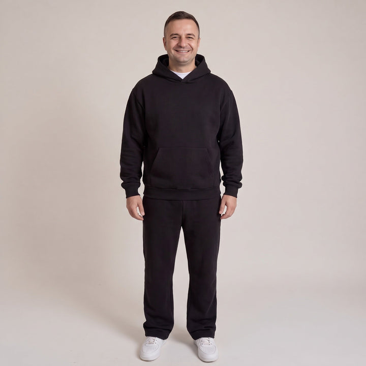 Man wearing black hooded tracksuit with relaxed hoodie and joggers | Grace Aura