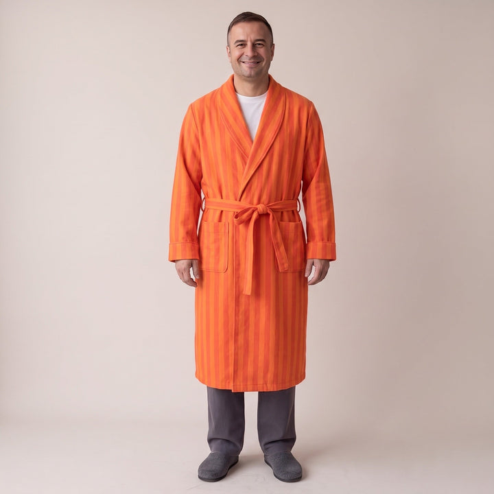 Man wearing orange striped flannel dressing gown with tie belt, gray pants | Grace Aura