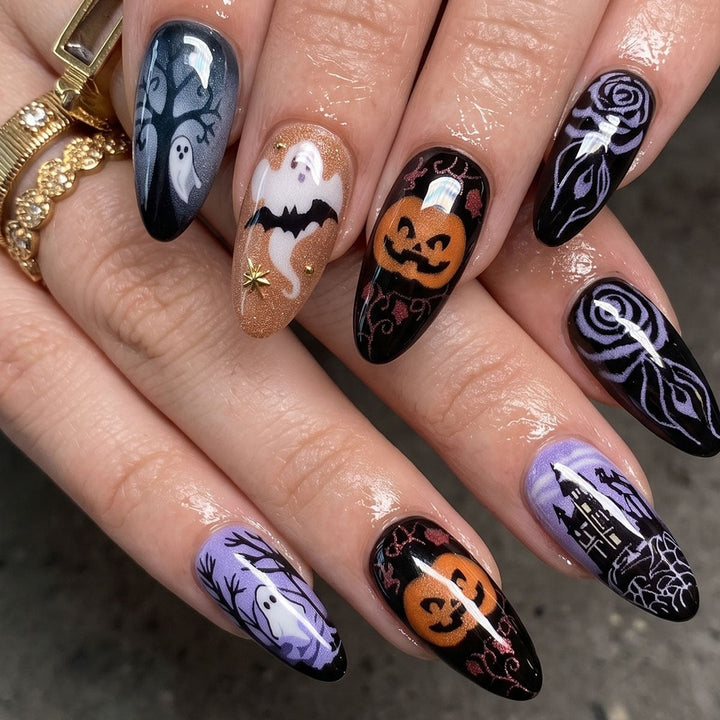 Hand wearing the Halloween press-on nails with ghosts and pumpkins
