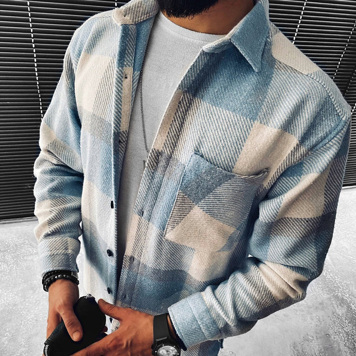 Man wearing blue and cream checkered flannel shacket over white shirt | Grace Aura