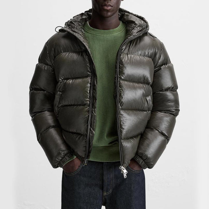 Man wearing shiny olive green quilted hooded puffer jacket with jeans | Grace Aura