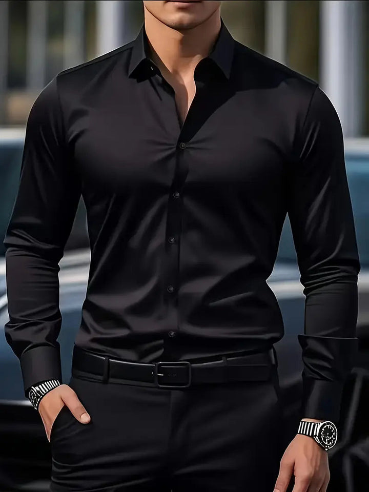 Man wearing black slim fit button up shirt with black pants | Grace Aura