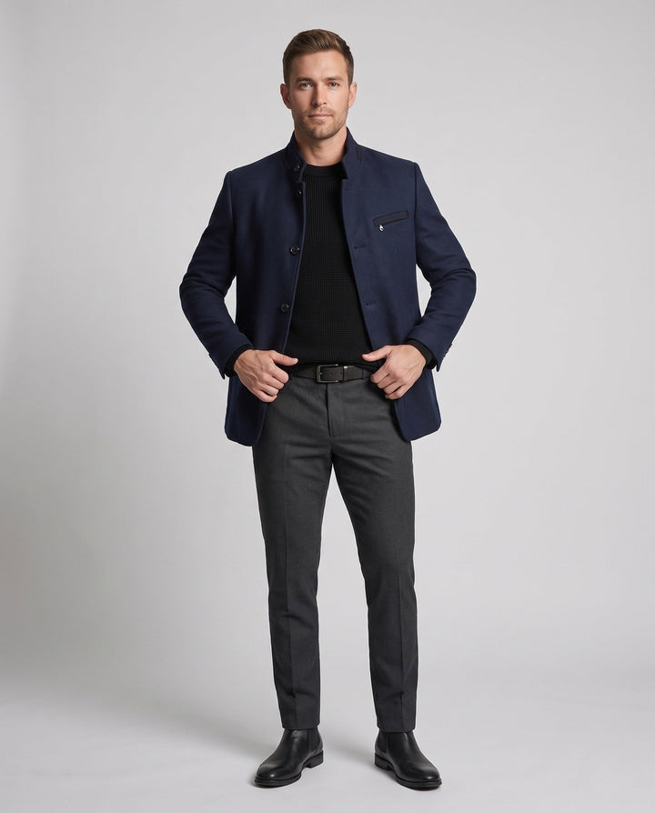 Men's navy short wool-blend coat with a funnel neck worn with grey trousers