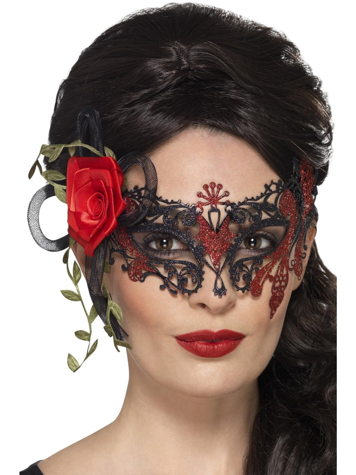 Woman wearing the black and red metal filigree mask with a red rose