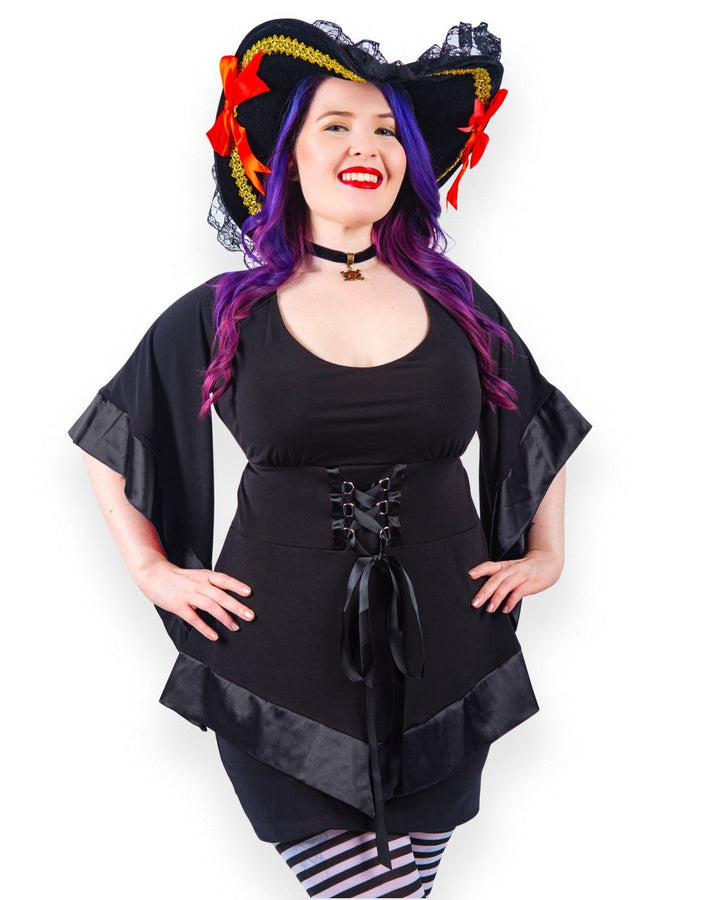 Woman in the black pirate outfit with the pirate hat and striped tights