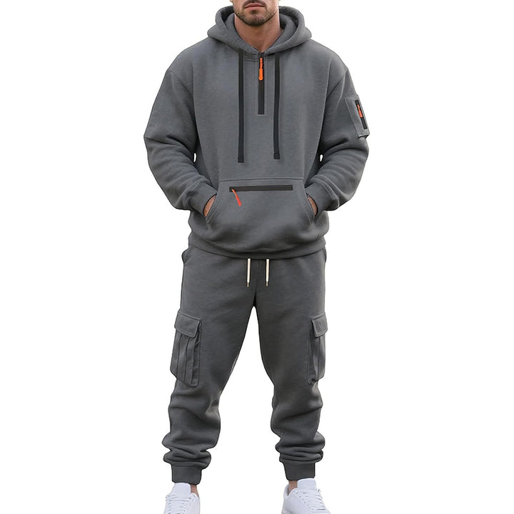 Man wearing grey cargo tracksuit with hood, zip pockets, worn outfit | Grace Aura