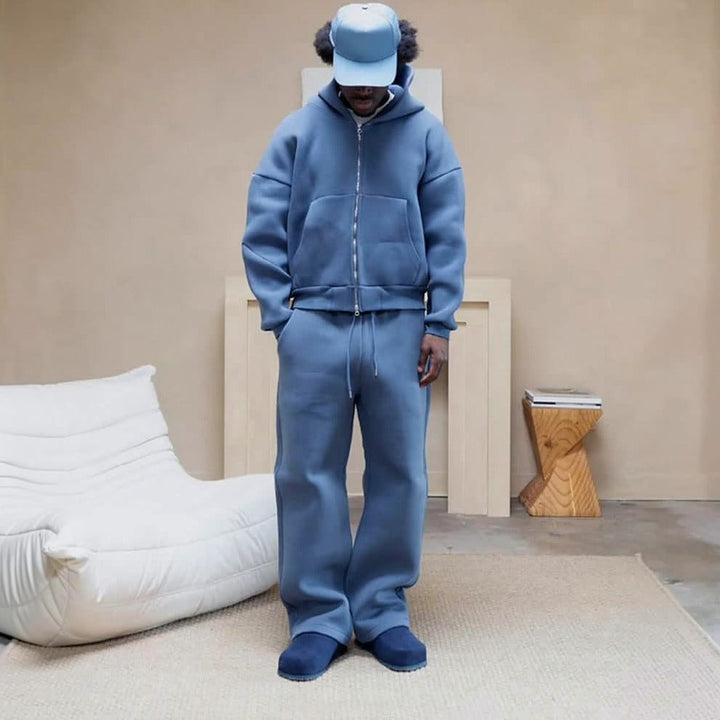 Man wearing blue zip hoodie and matching wide leg joggers, cap | Grace Aura