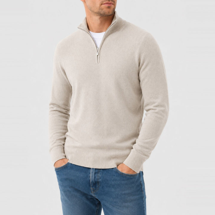 Man wearing beige quarter zip jumper with blue jeans, worn casually | Grace Aura