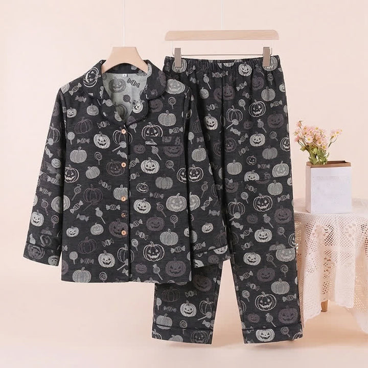 Black pajama set with pumpkin print, hanger and folded pants displayed | Grace Aura