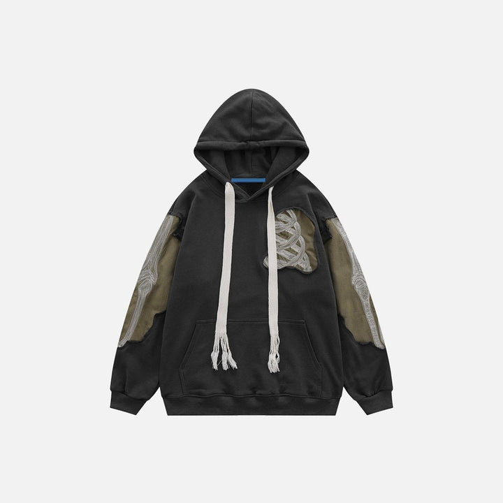 Black hoodie with embroidered patchwork skeleton design, drawstring hood, flat lay display | Grace Aura